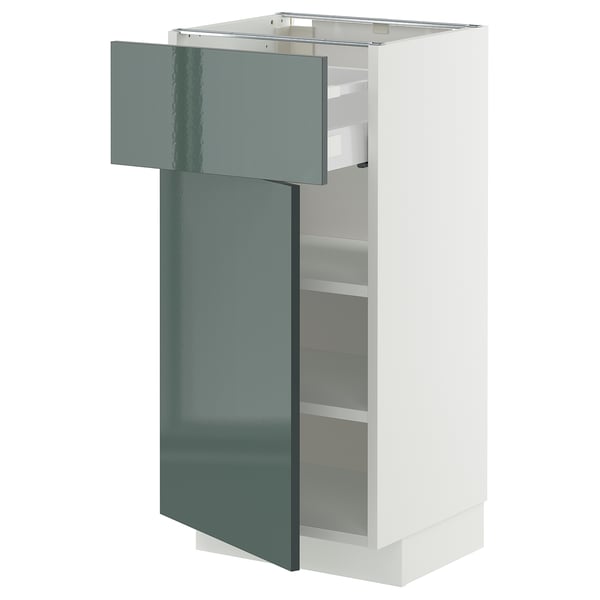 A modern white kitchen cabinet with a high-gloss grey-green door. The cabinet an exposed drawer and adjustable shelves.