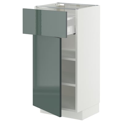 A modern white kitchen cabinet with a high-gloss grey-green door. The cabinet an exposed drawer and adjustable shelves.