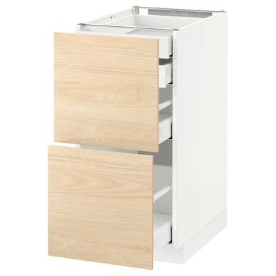 White METOD kitchen cabinet with light wood drawers, partially open.