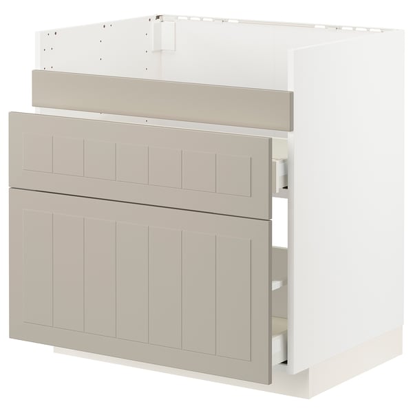 Ikea METOD kitchen unit in beige with beveled panels and drawers, part assembled.