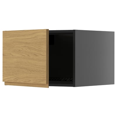 Modern kitchen cabinet with oak-textured door, dark interior.