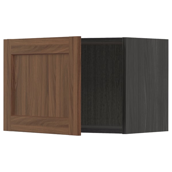 Two boxes, one plain walnut, one dark grey, showcasing METOD kitchen system doors.