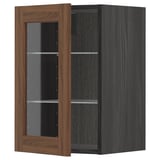 A METOD kitchen cabinet with walnut-finished glass doors and dark frame, featuring adjustable shelves.