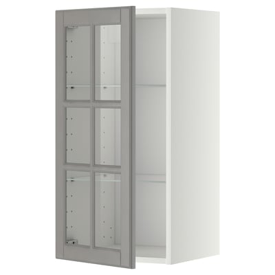 A white METOD kitchen cabinet with gray bodbyn glass doors, displaying a traditional design.