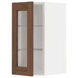 A METOD wall cabinet with a white frame and a walnut-finished glass door featuring adjustable shelves.