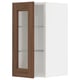 A METOD wall cabinet with a white frame and a walnut-finished glass door featuring adjustable shelves.
