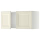 Two white METOD kitchen wall cabinets with beveled doors.