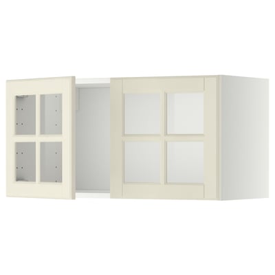 Two off-white METOD kitchen wall cabinets with glass doors and beveled edges.