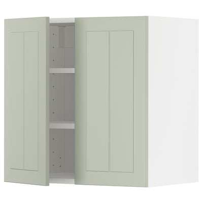 A light green METOD kitchen cabinet with two doors and adjustable shelves, set against a white background.