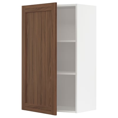 A white METOD kitchen wall cabinet with a single wooden door in walnut finish. It has one adjustable shelf inside and the door is slightly open.