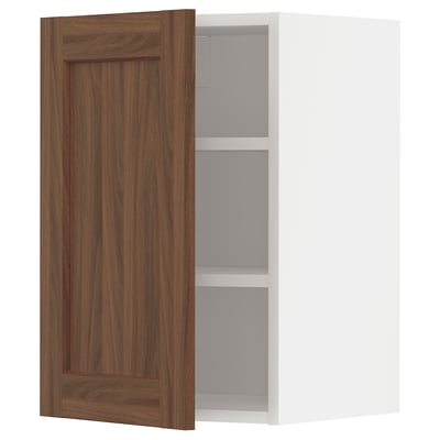 Walnut-colored kitchen cabinet with two shelves, door slightly open.