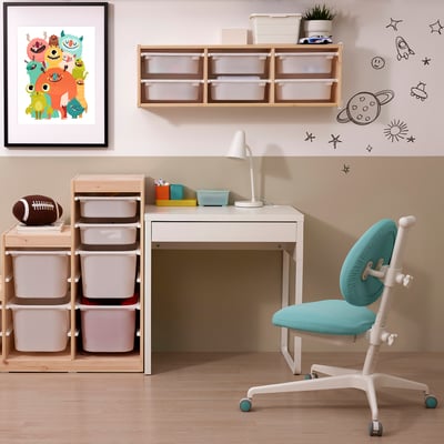 Kids workspace: white MICKE desk, blue chair, pink storage bins, artwork & decals.
