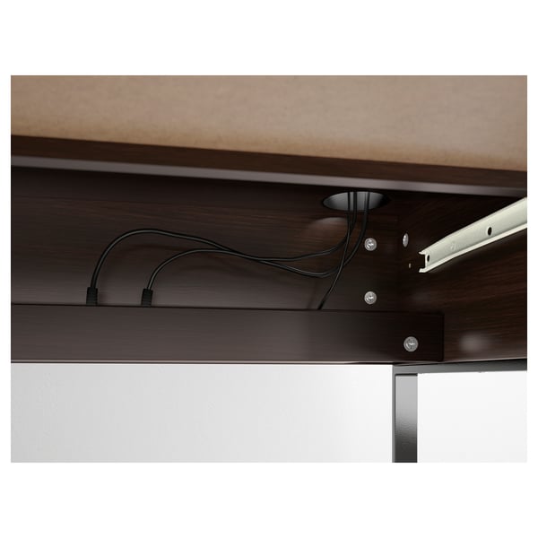 MICKE desks cable management system, showing organized wires and metal frame.