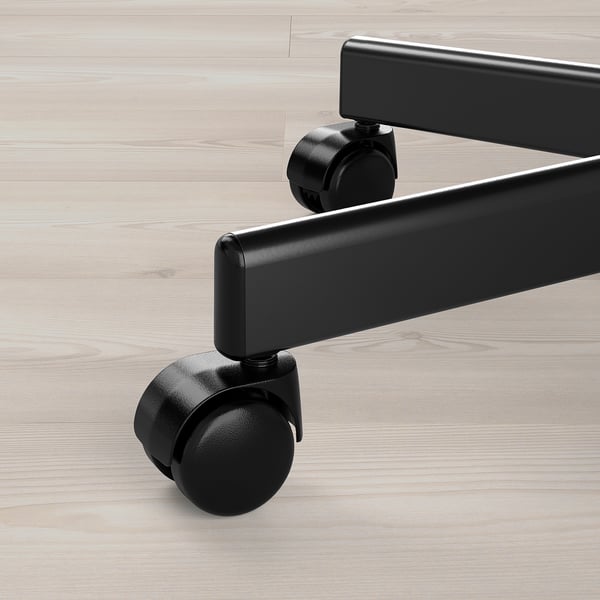 Black office chair casters on wooden floor, showing durable, smooth wheels and metal base.