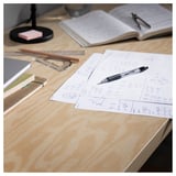 Wooden desk with open notebooks, pencils, ruler, and equations. Study or design workspace.