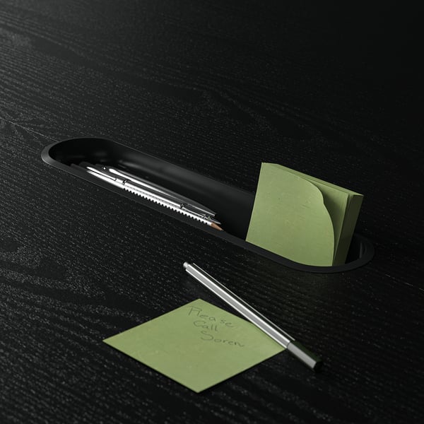 Black desk organizer holding pens and green sticky notes, one note reads please call boris.