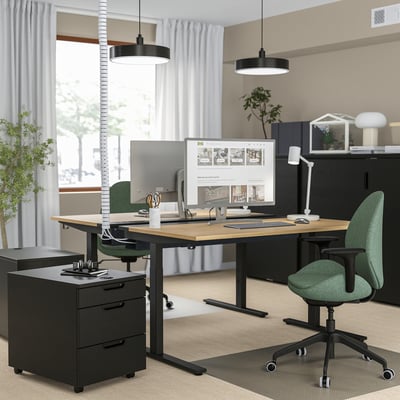 Modern black office setup: MITTZON height-adjustable desk with green chair, monitor, & plants.