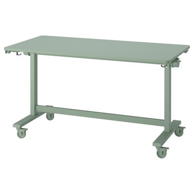 MITTZON: green adjustable work table on wheels with folded legs, ideal for flexible spaces.