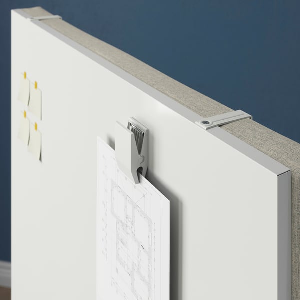 Whiteboard screen with hooks and papers attached.