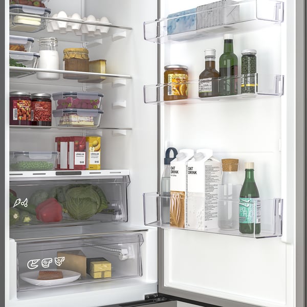 Fridge with adjustable shelves, led light, and humidity control. Vegetables and drinks stored neatly.