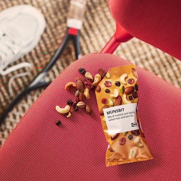 Snack bag labeled MUNSBIT, showing mix of nuts and berries, partially opened with contents spilled out.