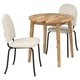 A NACKANÄS dining set with a round wooden table and two chairs in beige fabric.