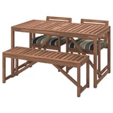 Brown acacia wood outdoor table, bench, and two chairs. Stripes on cushions.