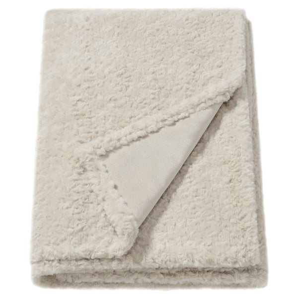 Fluffy off-white blanket, textured, folded rectangle, made from soft, recycled polyester.