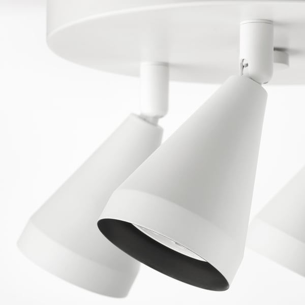 Modern white ceiling spotlights, three adjustable with precision engineering.