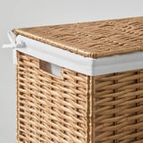 Hand-woven wicker laundry basket with white liner. Natural, durable, and stylish design.