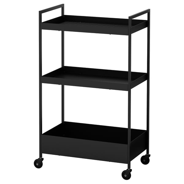 Depicts a black ikea NISSAFORS three-tiered trolley with wheels for easy portability. Its designed for storage and fits in small spaces.