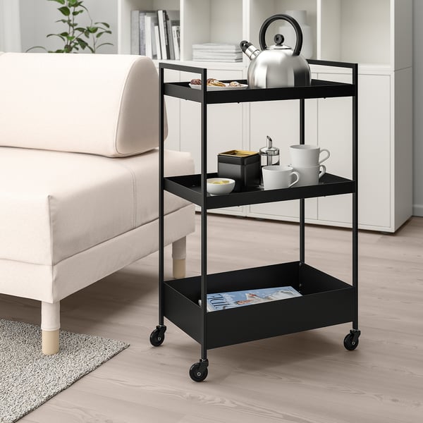Black NISSAFORS trolley with kettle, cups, in living room or kitchen.