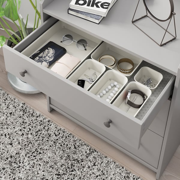 Open white dresser with NOJIG trays organizing jewelry and accessories.