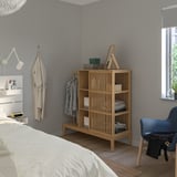 Minimalist bedroom with NORDKISA wardrobe, coat hook, blue chair, and bed with white sheets.