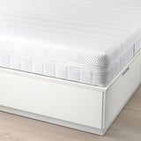 White bed frame with built-in drawers showcasing storage functionality and a mattress.