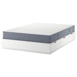 A white NORDLI bed frame with six storage drawers and a gray mattress.