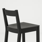 Modern black chair with curved back.