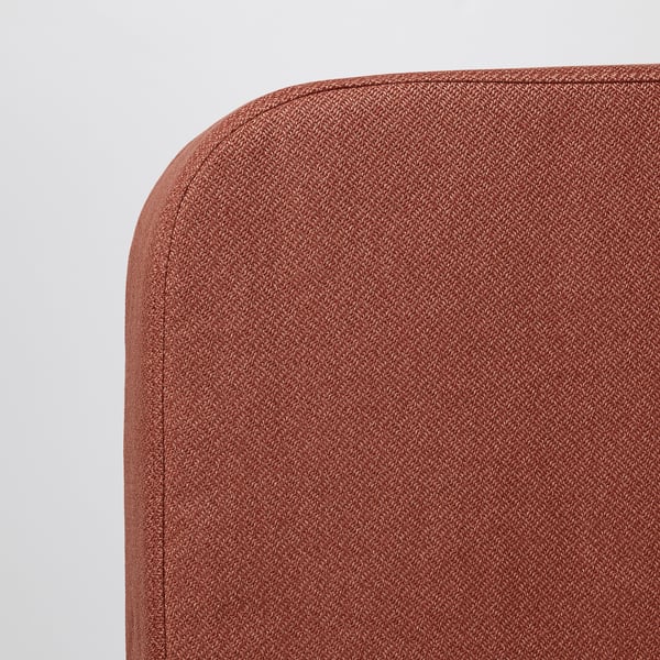 Close-up of plush, reddish-brown fabric on modern sofa bed, showcasing its high-quality texture and design.