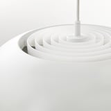 Modern white pendant light with concentric circles, emitting soft, glare-free illumination.