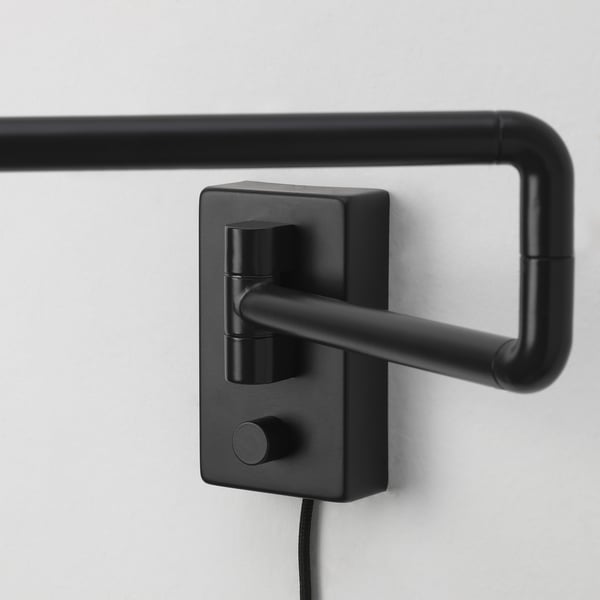 Black modern wall-mounted lamp with adjustable metal arm and knobs.