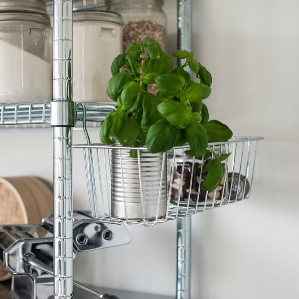 Silver shelf with green plant.