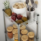 Shelf with fruits, bowls, and tools; wire basket with adjustable shelves.