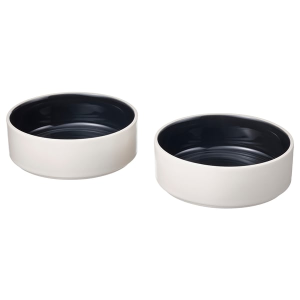 Two white ceramic bowls with dark interior, simple and modern design. Part of the OMBONAD series.