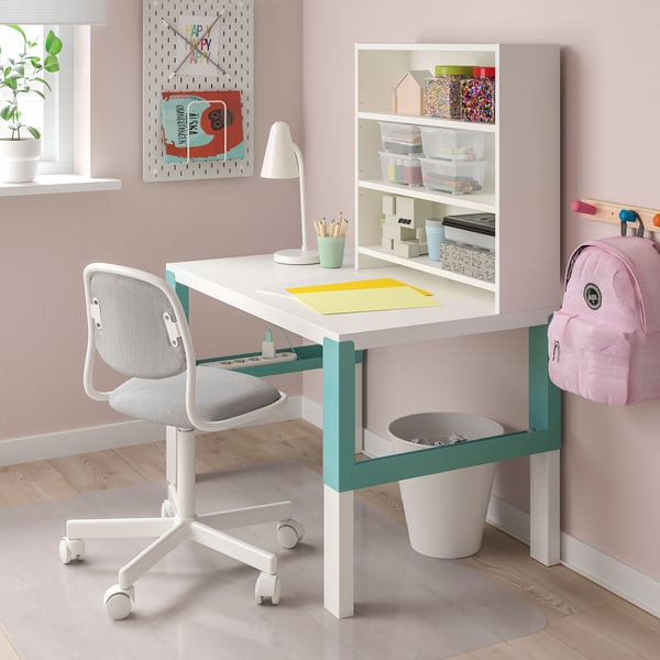 White childrens desk with green accents, chair, supplies, & shelves.