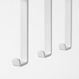 Three white hooks hang in a row, evenly spaced, attached to an unseen surface. Simple, clean, and functional.