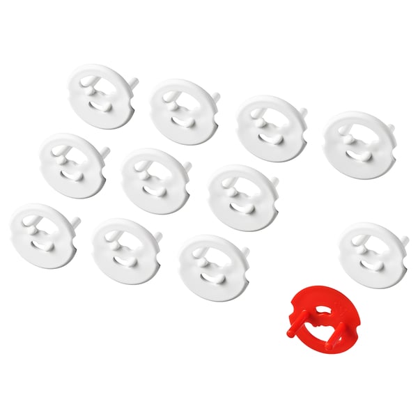 Eleven white and one red plastic safety plugs for blocking electrical sockets.