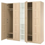 An IKEA PAX wardrobe in white with doors open, revealing shelves and hanging space. Light wood finish, rectangular shape, panel design.