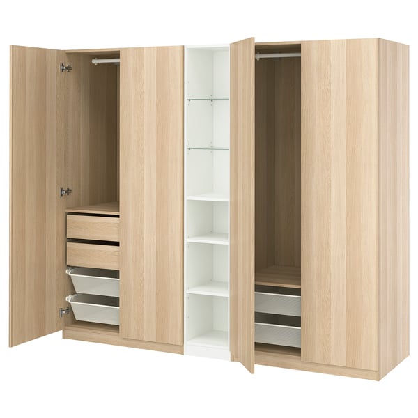 PAX wardrobe in light oak, three sections open displaying drawers, shelves, and hanging space with soft-closing hinges.