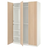 A white PAX wardrobe with light oak doors, open to reveal empty shelves.
