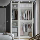 Open wardrobe displaying clothes and accessories, with shelves and storage boxes.